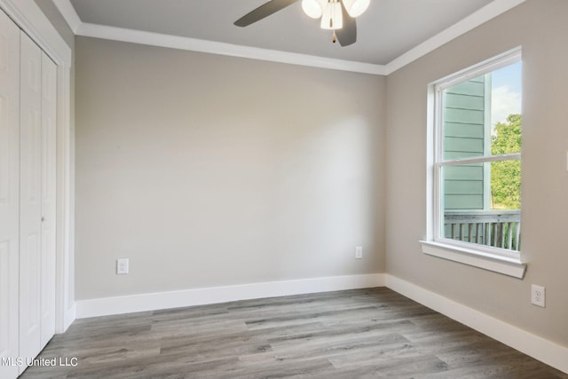 unfurnished bedroom with ornamental molding, a closet, ceiling fan, and light wood-type flooring