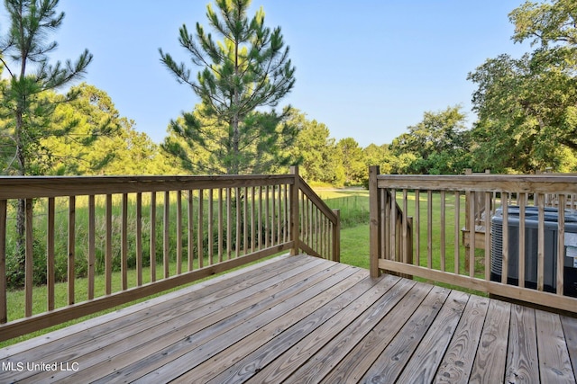 wooden deck with central AC and a lawn