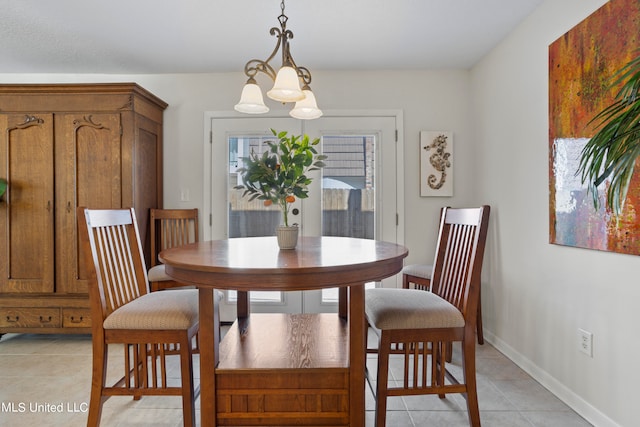 tiled dining space with an inviting chandelier