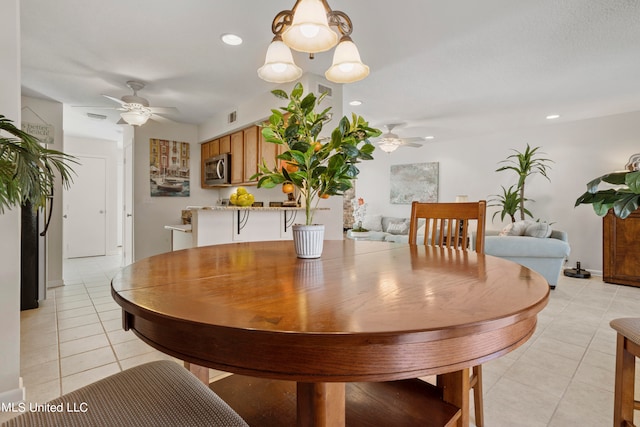 dining room with ceiling fan and light tile patterned flooring