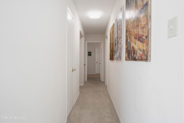 corridor featuring light colored carpet