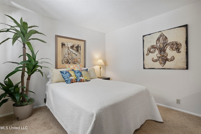 bedroom featuring light colored carpet and a textured ceiling