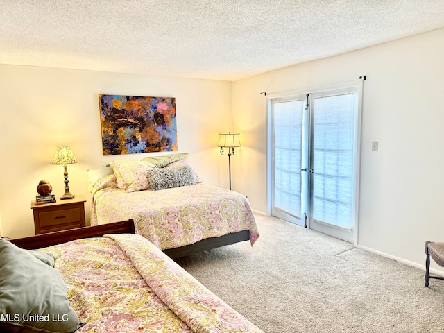 bedroom featuring carpet floors, a textured ceiling, and access to outside