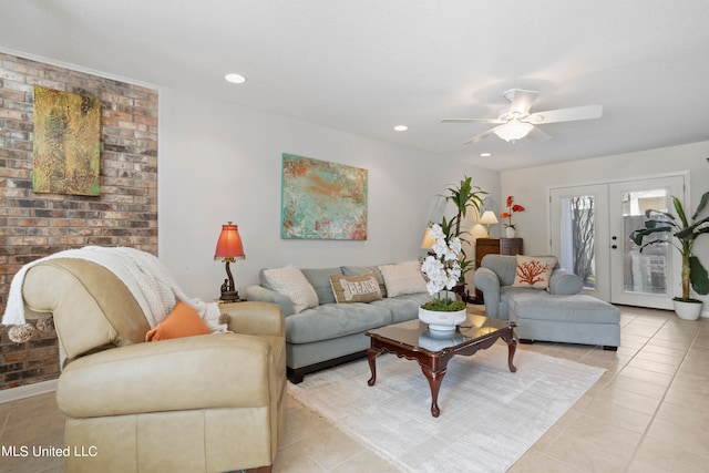 tiled living room with french doors, ceiling fan, and brick wall