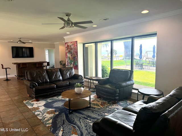 living room featuring tile patterned floors, crown molding, and ceiling fan