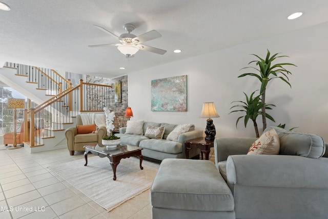 tiled living room featuring ceiling fan and a textured ceiling