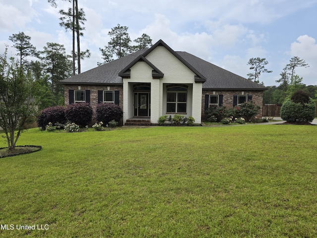 45 Carlsbad, Hattiesburg, MS 39402 - view of front of home featuring brick siding, fence, a front yard, and roof with shingles