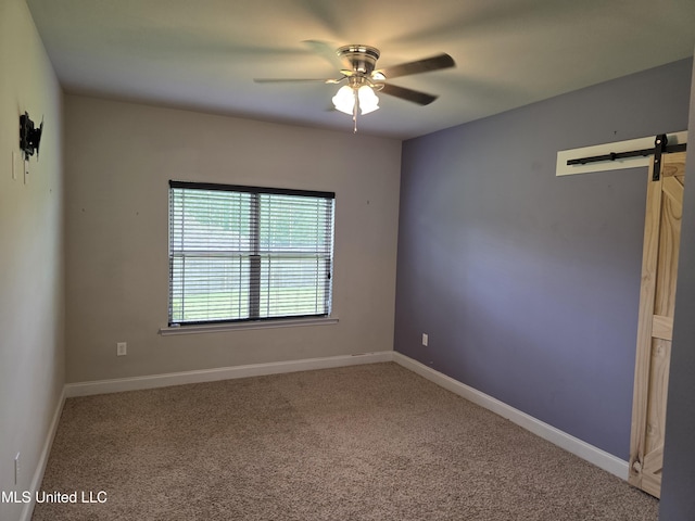 45 Carlsbad, Hattiesburg, MS 39402 - empty room with carpet floors, baseboards, a ceiling fan, and a barn door