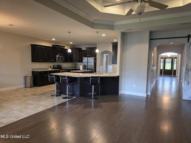 45 Carlsbad, Hattiesburg, MS 39402 - kitchen with a kitchen bar, arched walkways, appliances with stainless steel finishes, dark cabinets, and ornamental molding