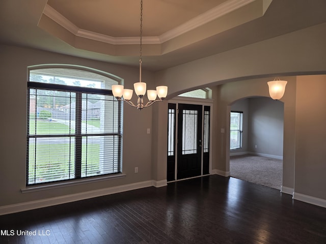 45 Carlsbad, Hattiesburg, MS 39402 - entryway with wood finished floors, baseboards, a raised ceiling, arched walkways, and a notable chandelier