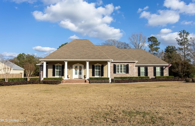 view of front of property with covered porch and a front lawn