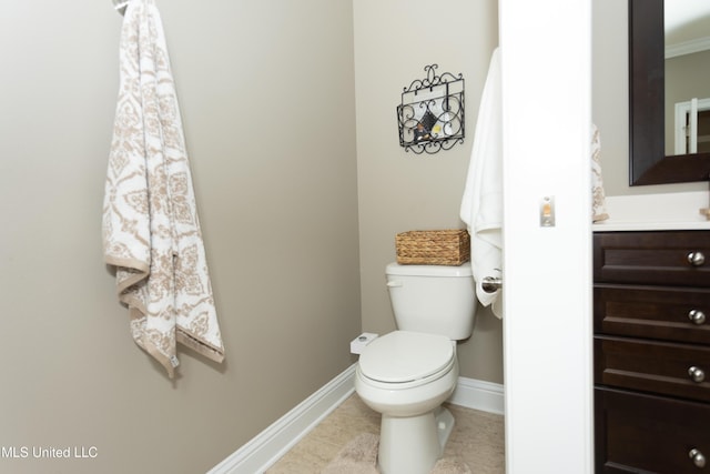 bathroom featuring vanity, tile patterned flooring, and toilet