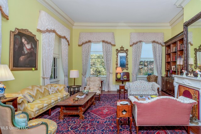 living area featuring hardwood / wood-style flooring and crown molding