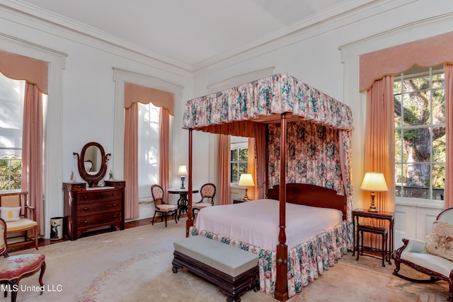 bedroom with multiple windows and crown molding