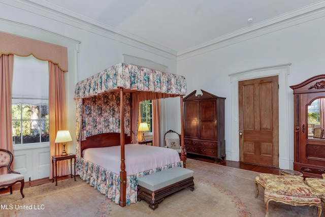 bedroom featuring ornamental molding and multiple windows