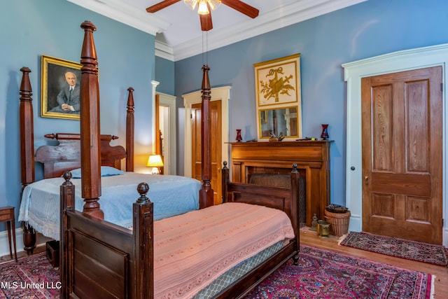 bedroom with hardwood / wood-style floors, ceiling fan, and ornamental molding