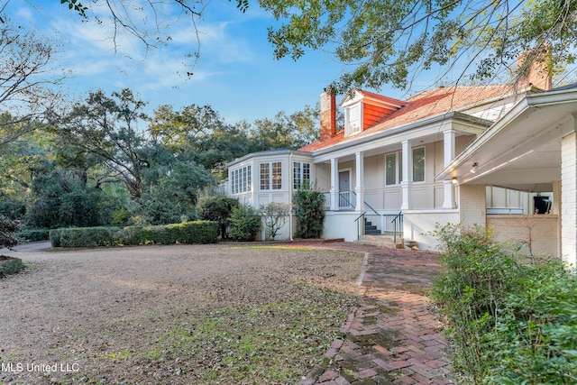 view of side of home with a porch