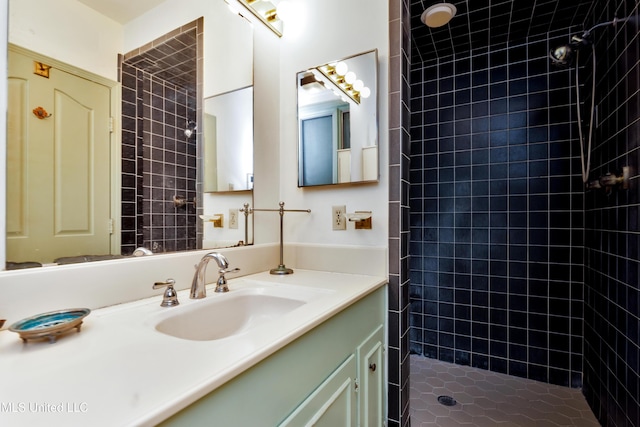 bathroom featuring vanity and tiled shower