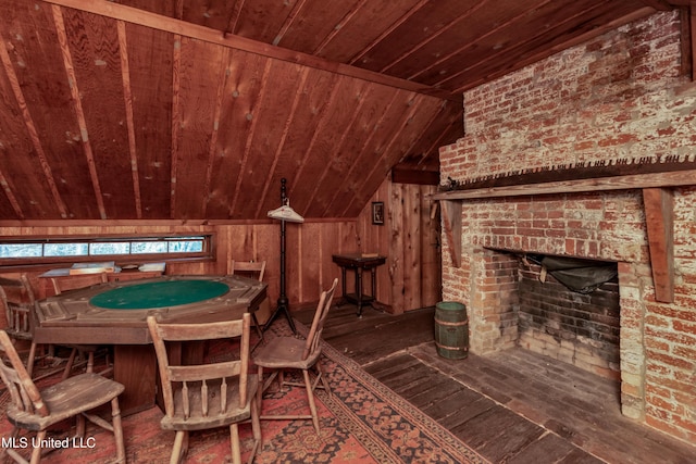 interior space featuring wooden walls, dark hardwood / wood-style floors, and lofted ceiling