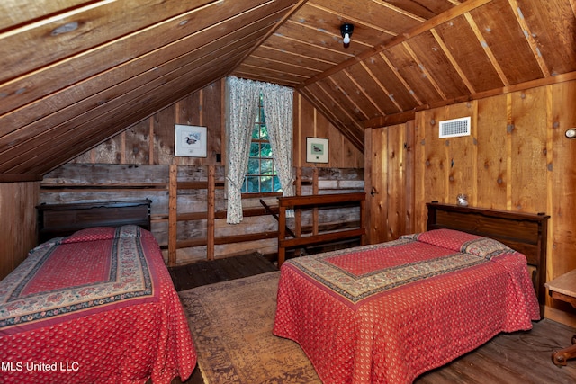 bedroom with hardwood / wood-style floors, lofted ceiling, and wooden walls