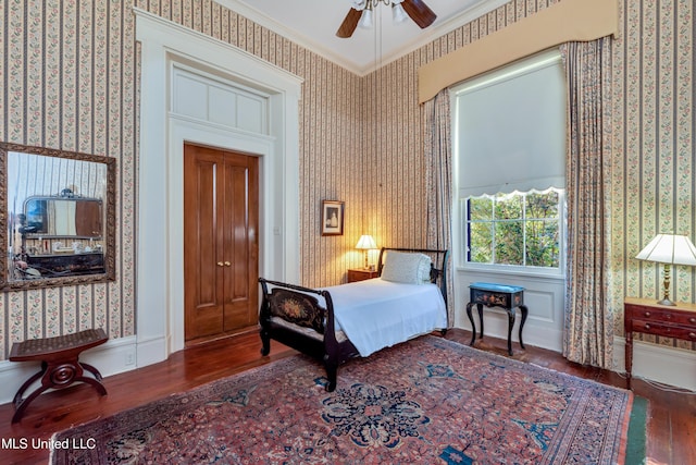 bedroom with ceiling fan, dark hardwood / wood-style flooring, and crown molding