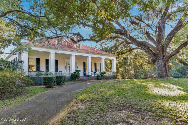 neoclassical / greek revival house featuring a porch