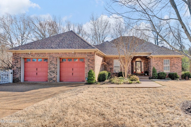 ranch-style home featuring brick siding, roof with shingles, fence, a garage, and driveway