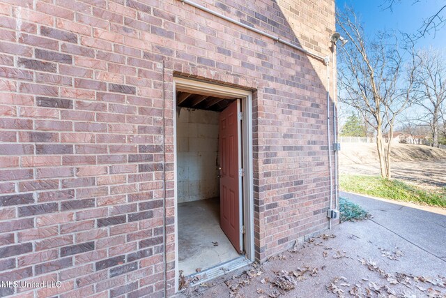 view of exterior entry with brick siding