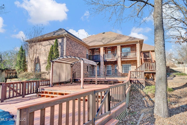 exterior space with brick siding, a wooden deck, and a balcony