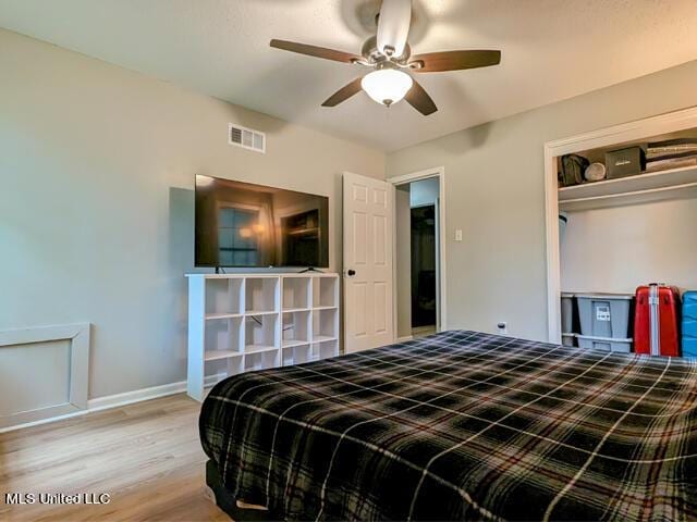 bedroom featuring ceiling fan, a closet, and light wood-type flooring