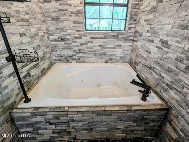 bathroom featuring tiled bath