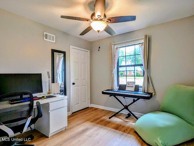 office area with ceiling fan and light hardwood / wood-style flooring