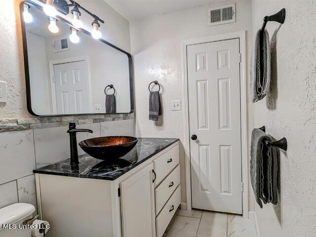 bathroom with vanity and toilet