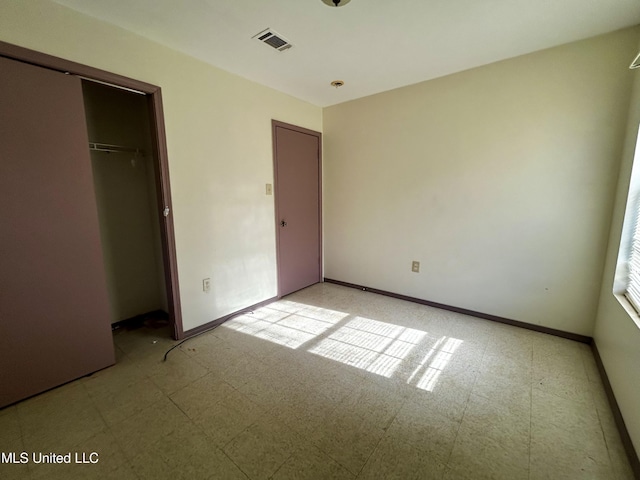 588 Church St, Fayette, MS 39069 - unfurnished bedroom with baseboards, light floors, a closet, and visible vents