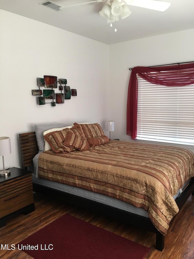 bedroom featuring dark hardwood / wood-style flooring and ceiling fan