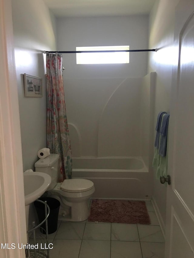 bathroom with tile patterned floors, shower / bath combination with curtain, and toilet