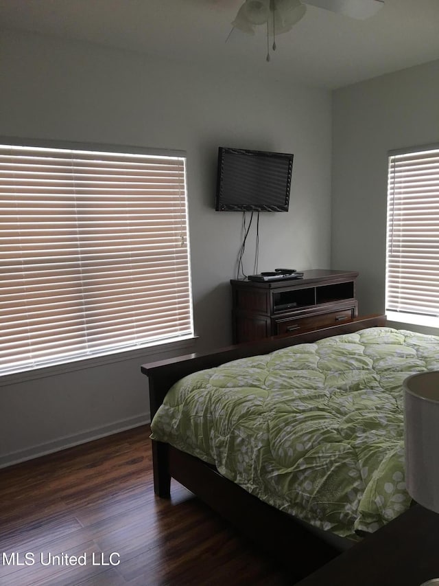 bedroom with ceiling fan and dark wood-type flooring