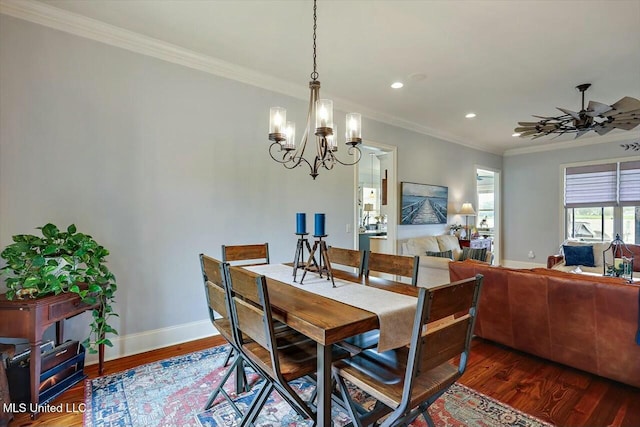 dining area with crown molding, dark hardwood / wood-style floors, and ceiling fan with notable chandelier