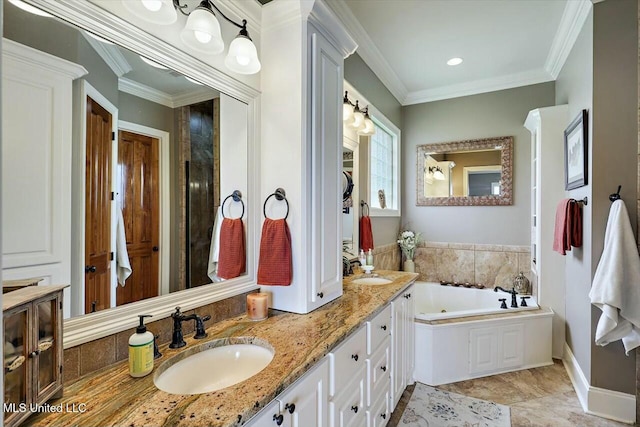 bathroom with crown molding, vanity, and a bathtub