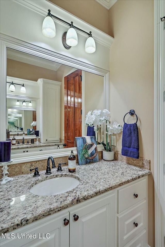 bathroom with vanity and ornamental molding