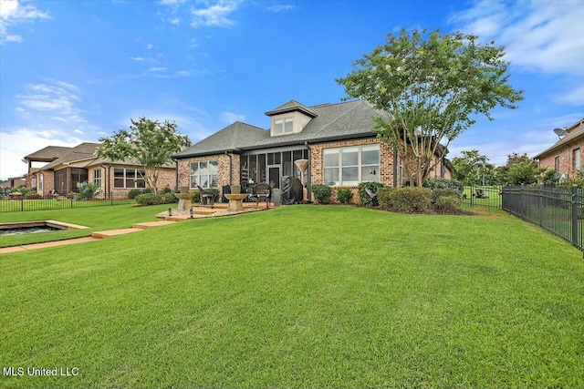 view of front of property featuring a front lawn and a sunroom