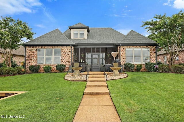 view of front of property featuring a sunroom and a front yard