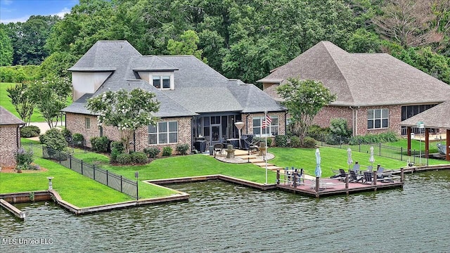 dock area featuring a water view and a yard