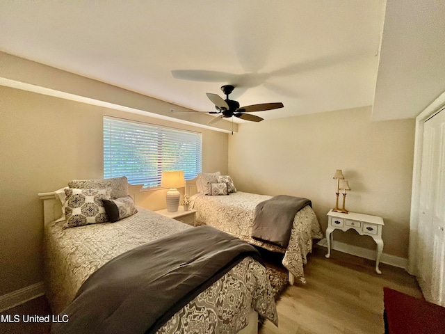 bedroom with light hardwood / wood-style flooring and ceiling fan