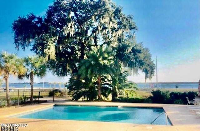 view of swimming pool with a water view