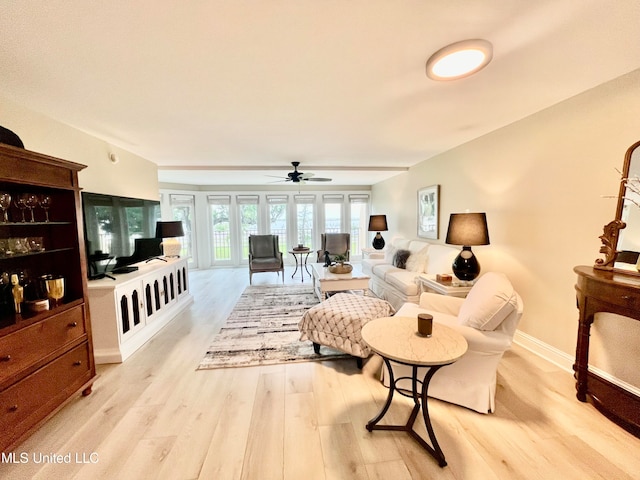 living room featuring light hardwood / wood-style flooring and ceiling fan