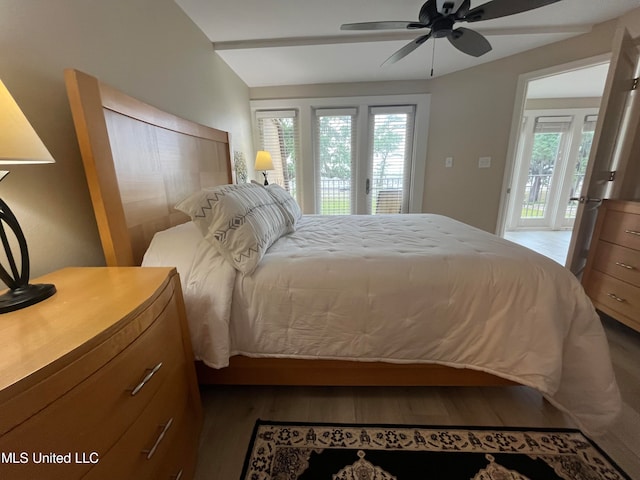 bedroom featuring multiple windows, hardwood / wood-style floors, access to exterior, and ceiling fan