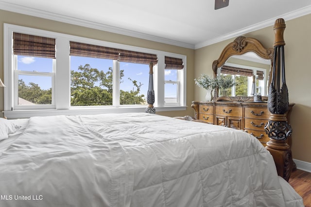 5200 W Beach Blvd, Gulfport, MS 39501 - bedroom featuring multiple windows, crown molding, wood finished floors, and a ceiling fan