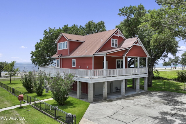 5200 W Beach Blvd, Gulfport, MS 39501 - view of front facade with driveway, a metal roof, and a wooden deck