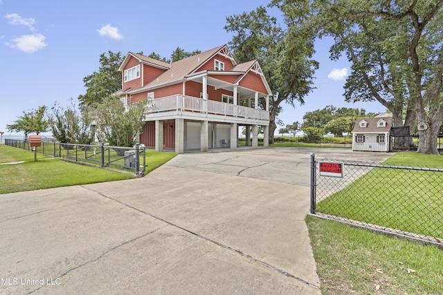 5200 W Beach Blvd, Gulfport, MS 39501 - view of front of house with driveway, an attached garage, and a gate